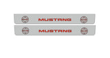 Catalog illustration of two long gray door sill plates with red Mustang lettering flanked by Bullitt target emblems on a white background.