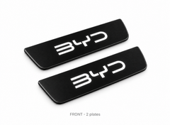 Matte PRO catalogue illustration of two black FRONT door sill plates with illuminated BYD lettering on a white background; vehicle dimensions not shown