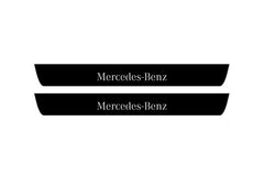 Catalog illustration of two black front door sill plates with Mercedes-Benz lettering.