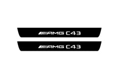 Catalog illustration of two black front door sill plates with AMG C43 lettering.