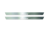 Two long silver-finished door sill plates with Caddy lettering on a light background, straight-on view.