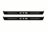 Catalogue illustration of two front black Matte PRO LED door sill plates with illuminated CTS lettering for Cadillac CTS II GM325; dimensions are selected during manufacture.