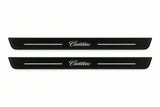 Catalogue illustration of two front black Matte PRO LED door sill plates with illuminated Cadillac lettering for Cadillac Escalade; dimensions are selected during manufacture.