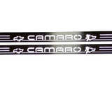Close-up of white Camaro lettering, Chevrolet bowtie emblems and horizontal stripes on dark reflective door sill plates.