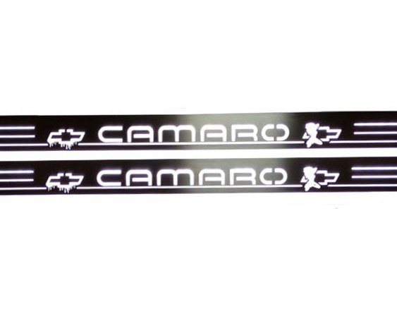 Close-up of white Camaro lettering, Chevrolet bowtie emblems and horizontal stripes on dark reflective door sill plates.