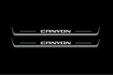 Two long door sill plates with Canyon lettering and edges illuminated in white, straight-on view on a dark background.