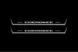 Two long door sill plates with Cherokee lettering and edges illuminated in white, straight-on view on a dark background.