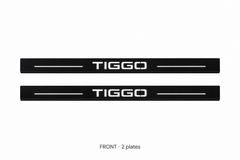 Matte PRO catalogue illustration: two flat black FRONT plates with illuminated TIGGO lettering and top lines on white; not exact vehicle dimensions