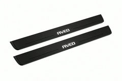 Catalogue illustration of two front black Matte PRO LED door sill plates with illuminated Aveo lettering for Chevrolet Aveo II T300; dimensions are selected during manufacture.