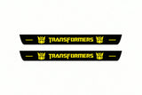 Catalogue illustration of two front black Matte PRO LED door sill plates with illuminated Transformers Decepticon lettering for Chevrolet Camaro E37; dimensions are selected during manufacture.