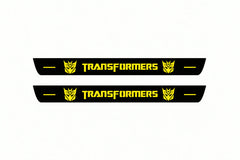 Catalogue illustration of two front black Matte PRO LED door sill plates with illuminated Transformers Decepticon lettering for Chevrolet Camaro E37; dimensions are selected during manufacture.