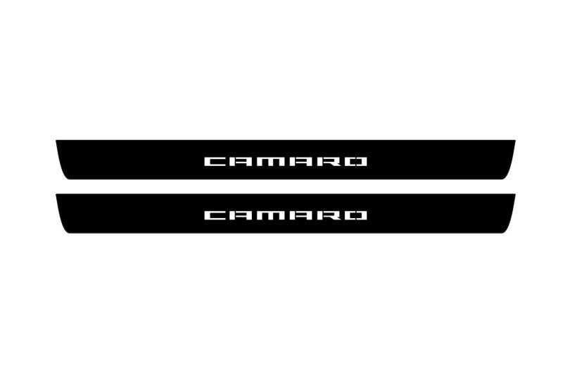 Catalog illustration of two black front door sill plates with Camaro lettering.