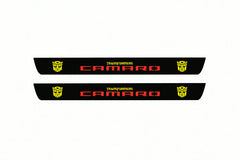 Catalogue illustration of two front black Matte PRO LED door sill plates with illuminated Camaro Transformers lettering for Chevrolet Camaro VI; dimensions are selected during manufacture.