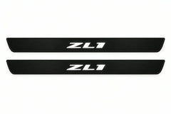 Catalogue illustration of two front black Matte PRO LED door sill plates with illuminated ZL1 lettering for Chevrolet Camaro VI; dimensions are selected during manufacture.