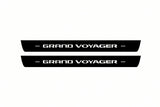 Catalogue illustration of two front black Matte PRO LED door sill plates with illuminated Grand Voyager lettering for Chrysler Grand Voyager V; dimensions are selected during manufacture.