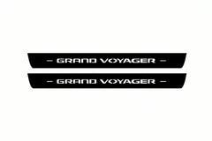 Catalogue illustration of two front black Matte PRO LED door sill plates with illuminated Grand Voyager lettering for Chrysler Grand Voyager V; dimensions are selected during manufacture.
