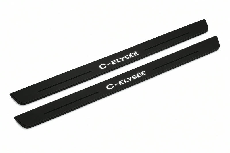 Catalogue illustration of two front black Matte PRO LED door sill plates with illuminated C-Elysee lettering for Citroen C-Elysee; dimensions are selected during manufacture.