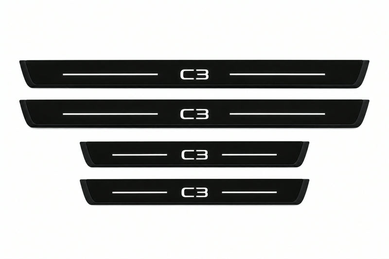 Catalog illustration of two front and two rear black Matte PRO LED door sill plates with illuminated C3 lettering for Citroën C3 B618.