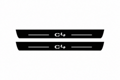 Catalogue illustration of two black Matte PRO front sill plates with illuminated C4 lettering and straight top lines. Rear plates are not pictured; dimensions are selected for Citroën C4 B7 during manufacture.