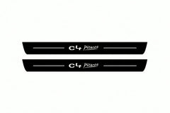 Catalogue illustration of two front black Matte PRO LED door sill plates with illuminated C4 Picasso lettering for Citroen C4 Picasso I; dimensions are selected during manufacture.