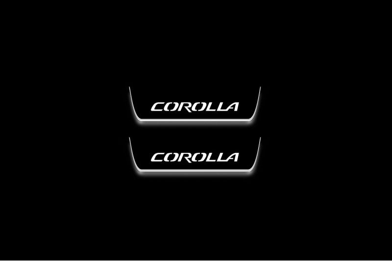 Two short door sill plates with Corolla lettering and edges illuminated in white, straight-on view on a dark background.