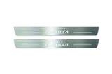 Two long silver-finished door sill plates with Corolla lettering on a light background, straight-on view.