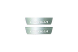 Two short silver-finished door sill plates with Corolla lettering on a light background, straight-on view.