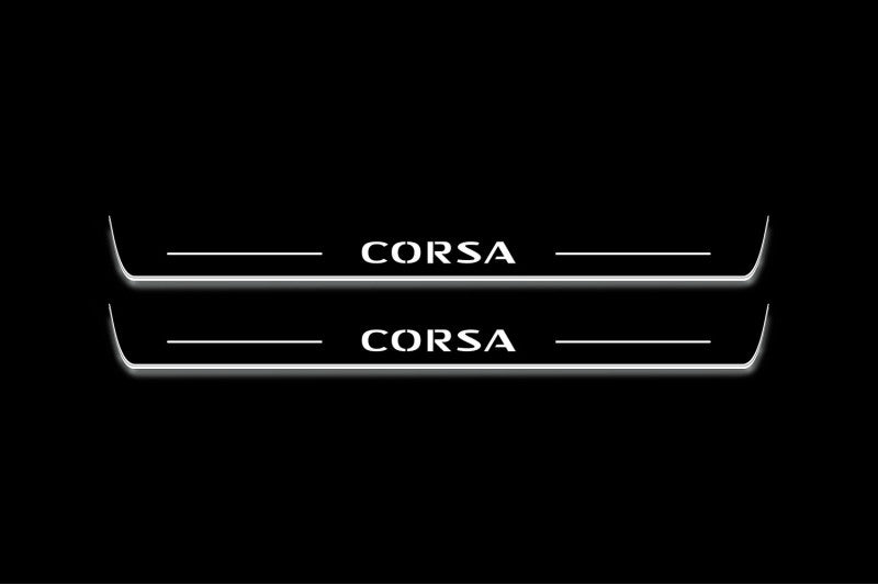 Two long door sill plates with Corsa lettering and edges illuminated in white, straight-on view on a dark background.