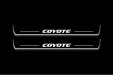 Ford Mustang VI S550 2015+ LED door sill plates in stainless steel with Coyote logo