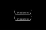 Two short door sill plates with Crosstrek lettering and edges illuminated in white, straight-on view on a dark background.