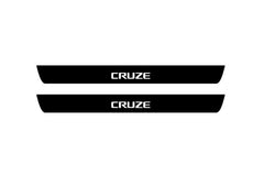 Catalog illustration of two black front door sill plates with Cruze lettering.