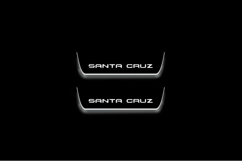 Hyundai Santa Cruz NX4 2021+ illuminated entry guards in stainless steel with Santa Cruz logo