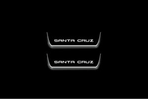 Hyundai Santa Cruz NX4 2021+ illuminated entry guards in stainless steel with Santa Cruz logo