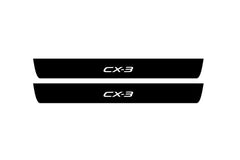 Catalog illustration of two black front door sill plates with CX-3 lettering.