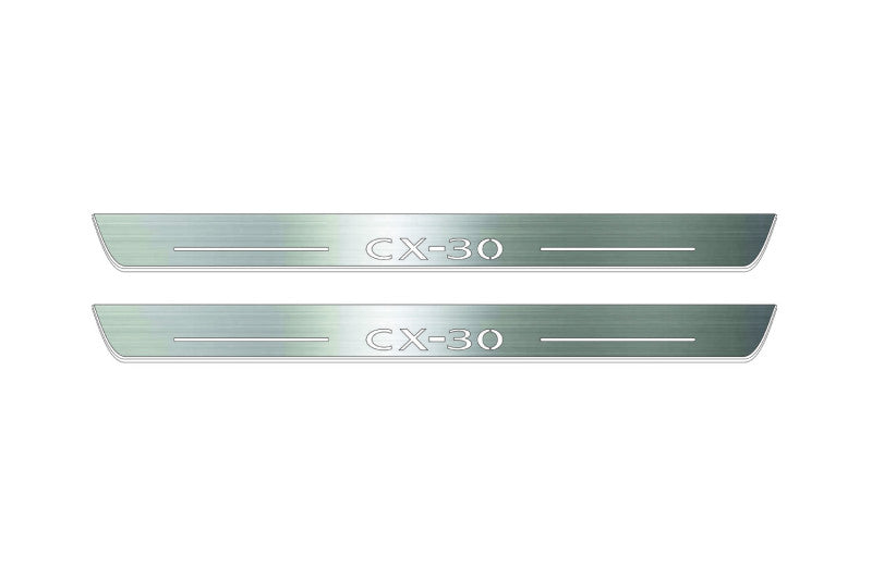Two long silver-finished door sill plates with CX-30 lettering on a light background, straight-on view.
