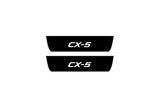 Mazda CX-5 II 2017+ entry guards in matte black coated stainless steel with CX-5 logo