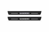Catalogue illustration showing 2 black Matte PRO LED door sill plates with white Sandero lettering for Dacia Sandero B8; dimensions are selected during manufacture.
