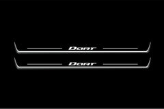 Two long door sill plates with Dart lettering and edges illuminated in white, straight-on view on a dark background.