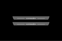 Catalog illustration of two long gray door sill plates with white Citroën lettering and horizontal lines on a black background.