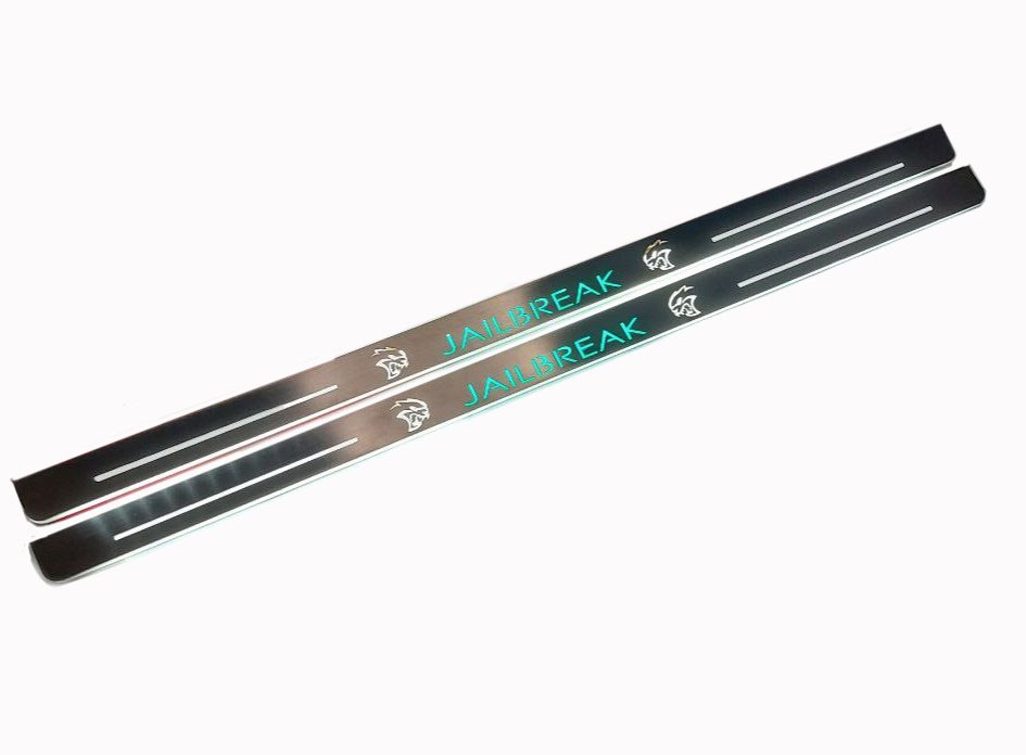 Two long reflective door sill plates with turquoise Jailbreak lettering and Hellcat-head emblems, angled view.
