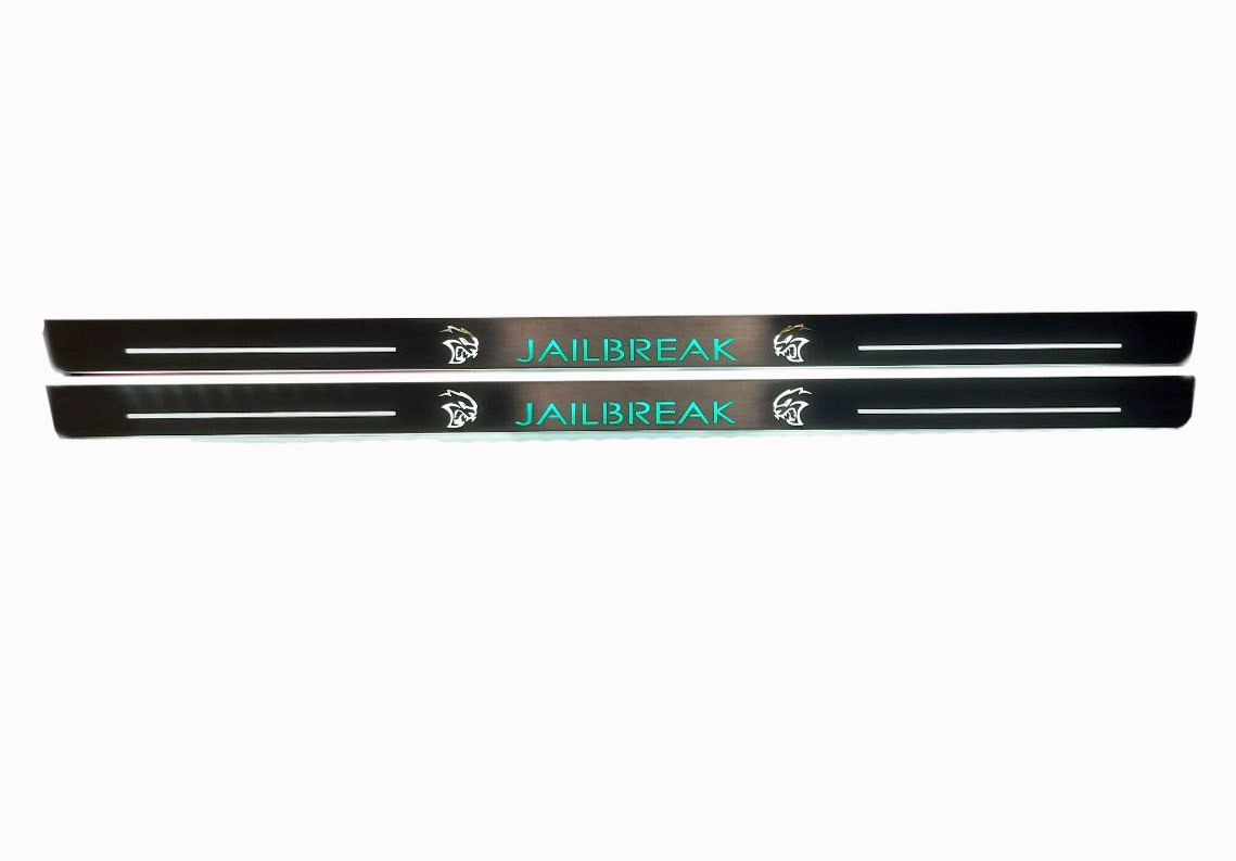 Two long reflective door sill plates with turquoise Jailbreak lettering and Hellcat-head emblems, straight-on view.