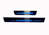 One long and one short dark door sill plate with blue Charger lettering and horizontal lines on a light background.
