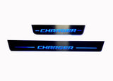 One long and one short door sill plate with Charger lettering and illuminated blue edges.