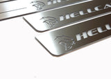 Close-up of Hellcat lettering and head emblems on silver-finished door sill plates.