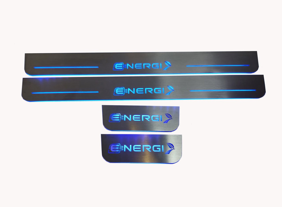 Four reflective door sill plates with blue Energi lettering and plug-and-arrow emblems on a light background.