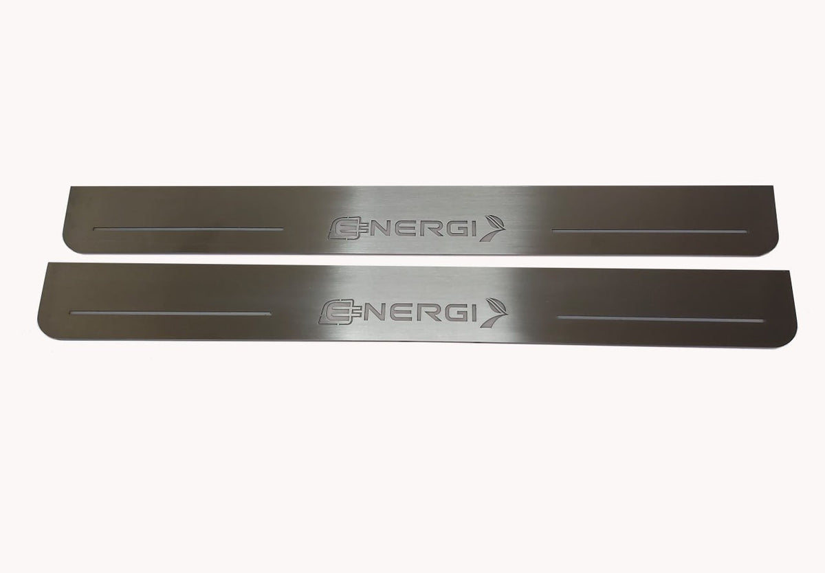 Two long silver-finished door sill plates with unframed Energi lettering, plug and arrow emblems.