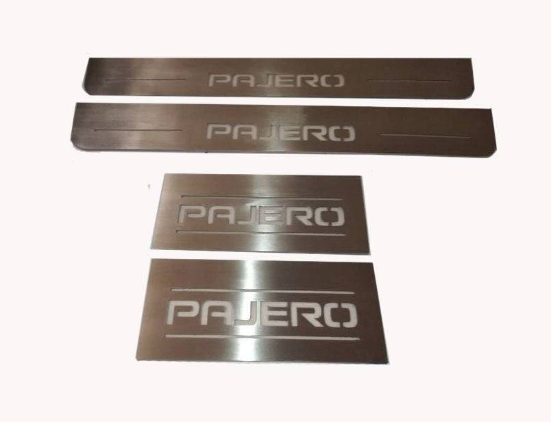 Four silver-finished Pajero door sill plates: a long narrow pair and a short rectangular pair.