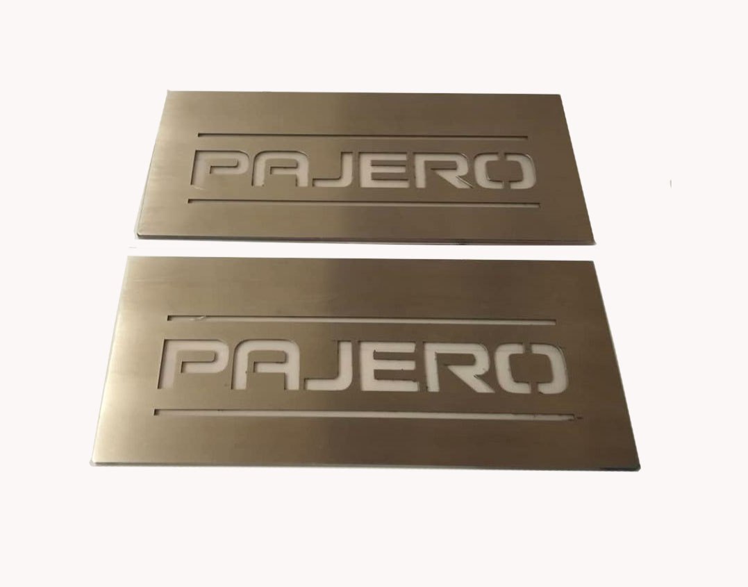 Two short rectangular silver-finished plates with Pajero lettering.