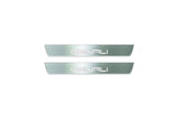 Two short silver-finished door sill plates with Denali lettering on a light background, straight-on view.