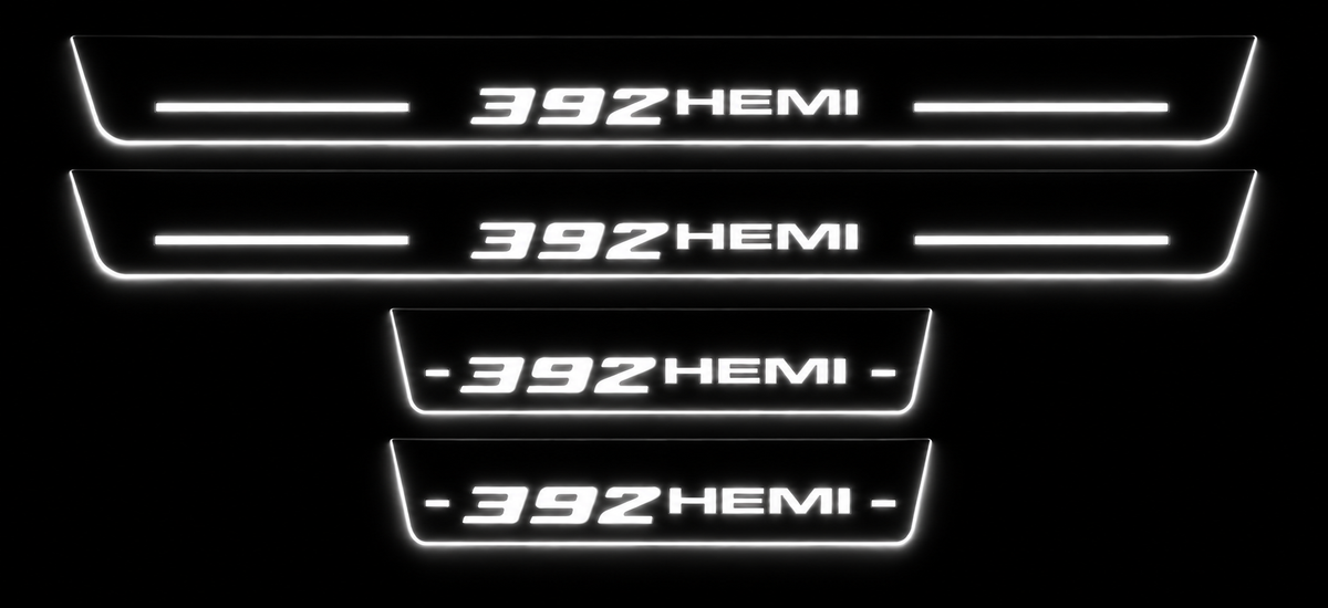 Four Dodge 392 HEMI stainless steel door sills in darkness with white LED lettering, bars and illuminated side edges.